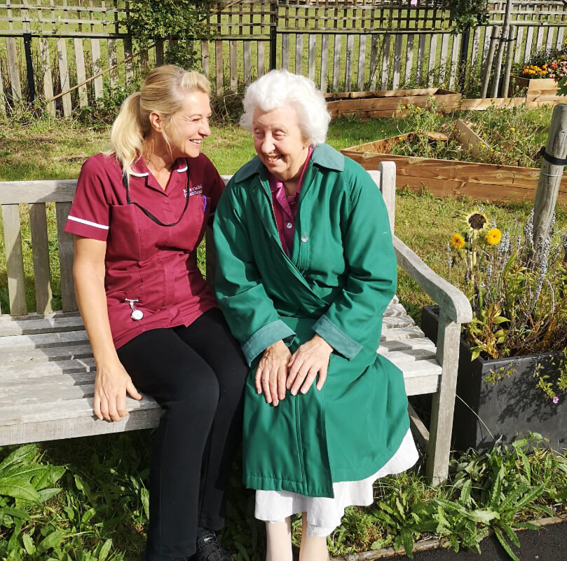 Elderly lady with female carer
